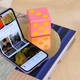 A photo of the Galaxy Z Flip 3 bent open and sitting on a book